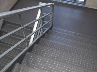Stair treads are installed with round projection pattern checker plate.
