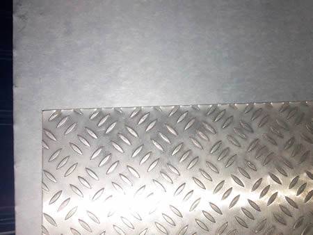 A piece of aluminum plate and piece of checker plate.