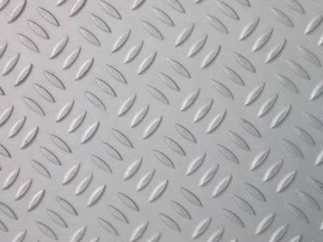 A piece of aluminum checker plate with raised rice shaped projections.