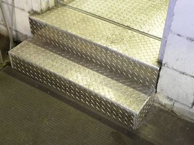 Stair treads are installed with diamond projection pattern checker plate.