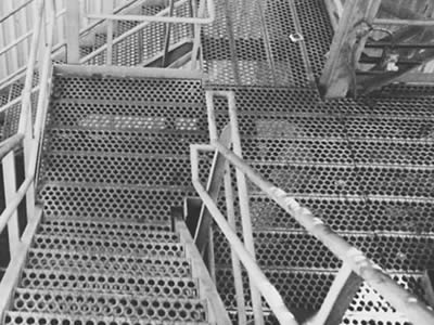 A picture includes many stair treads; these stair treads are formed of o-grip safety gratings.