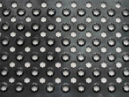 A piece of stainless steel checker plate with raised and flat flower shaped projections.