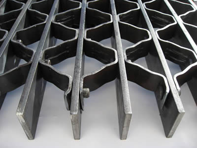 A part of a riveted stair tread steel grating shows its details.